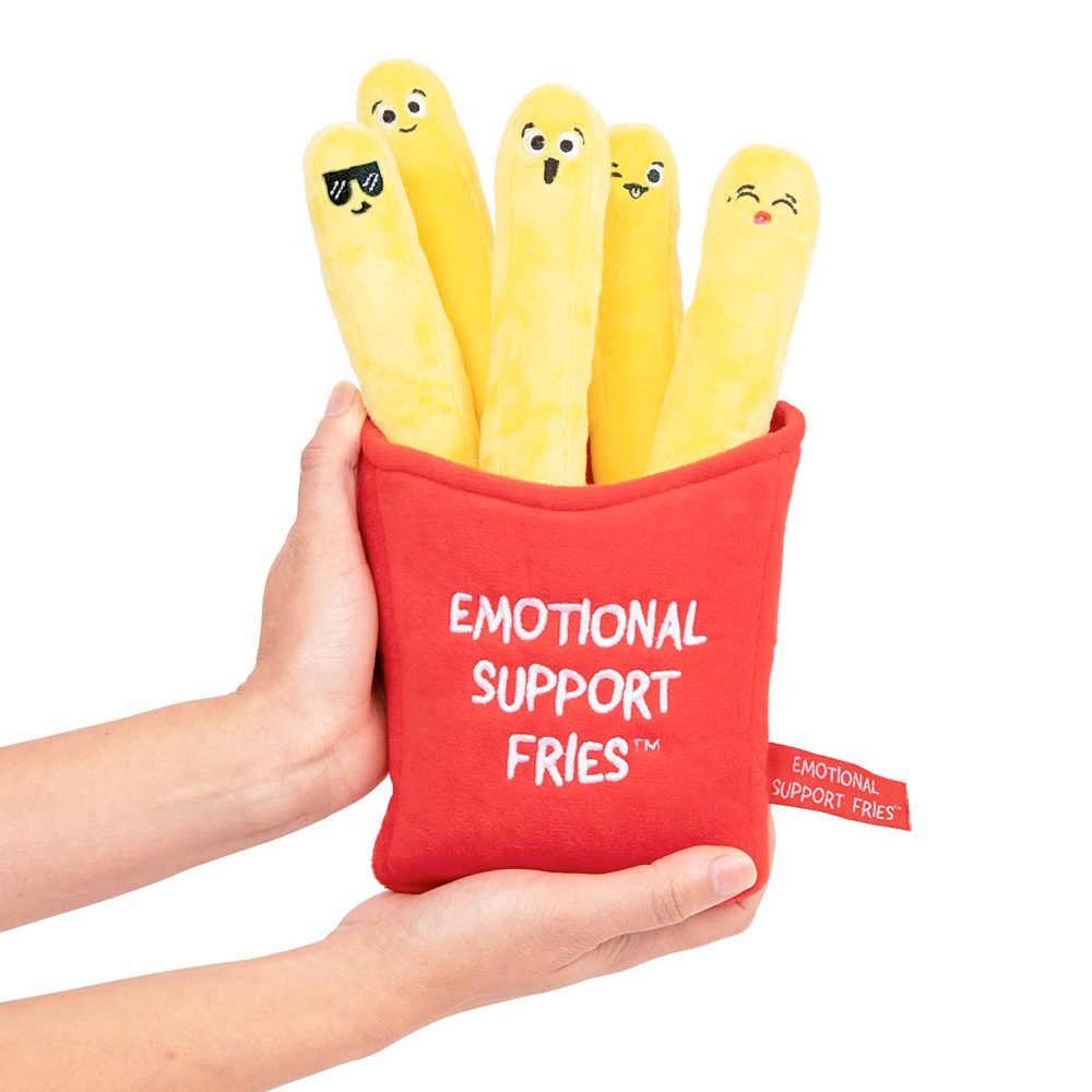 Two hands holding a plushie of five yellow French fries with faces in a red holder with white text on it